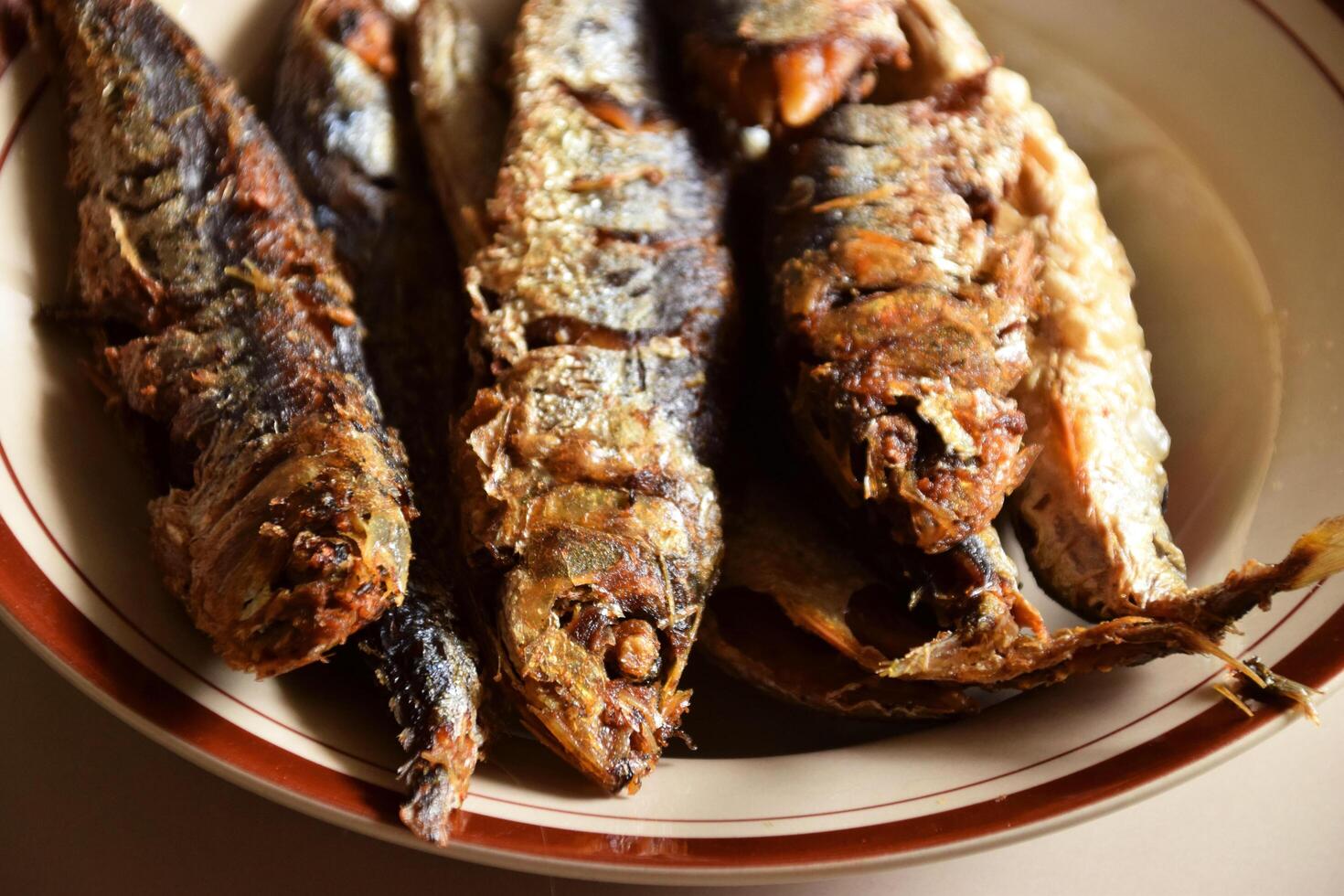 Closeup of traditional Indonesian fried fish on a plate photo