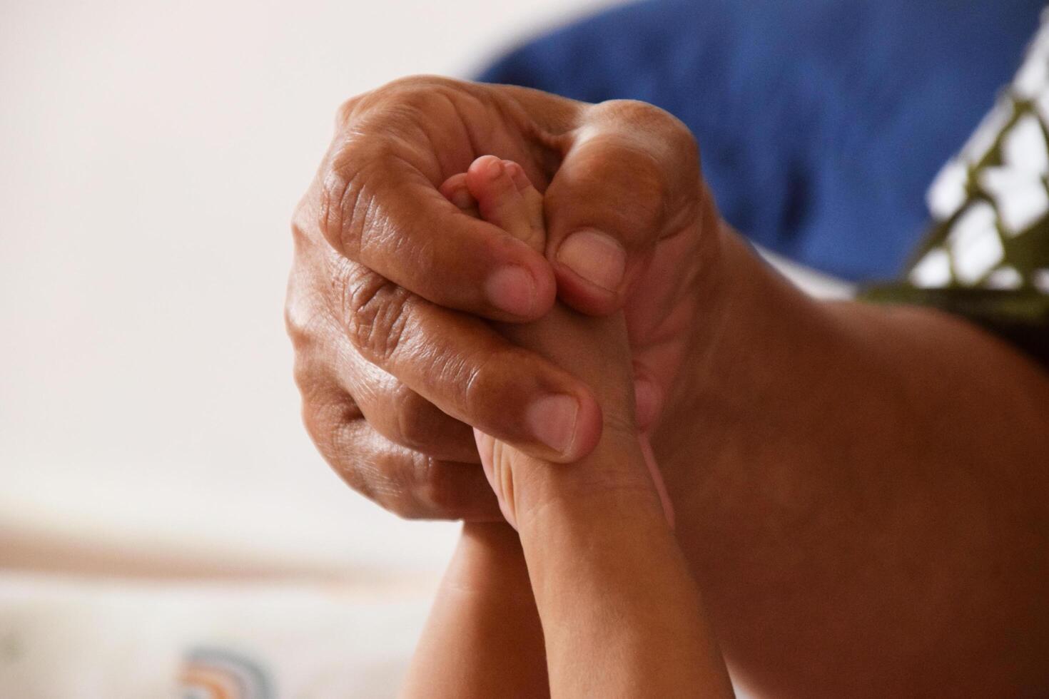Mother cleaning baby feet with love and care photo