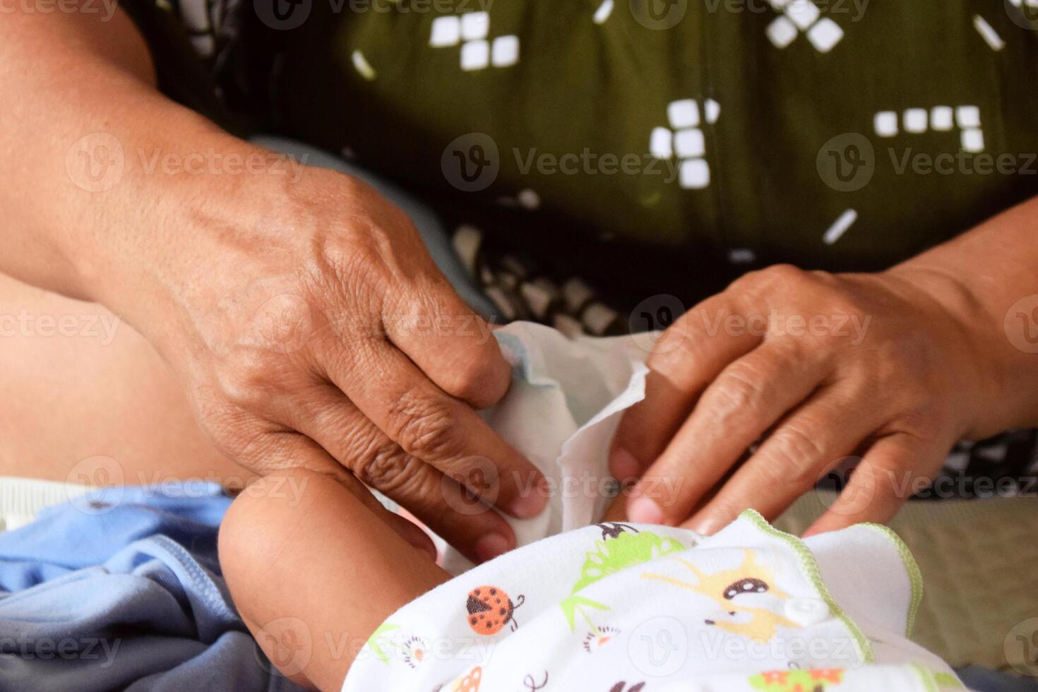 Close up of hands cleaning baby during diaper change photo