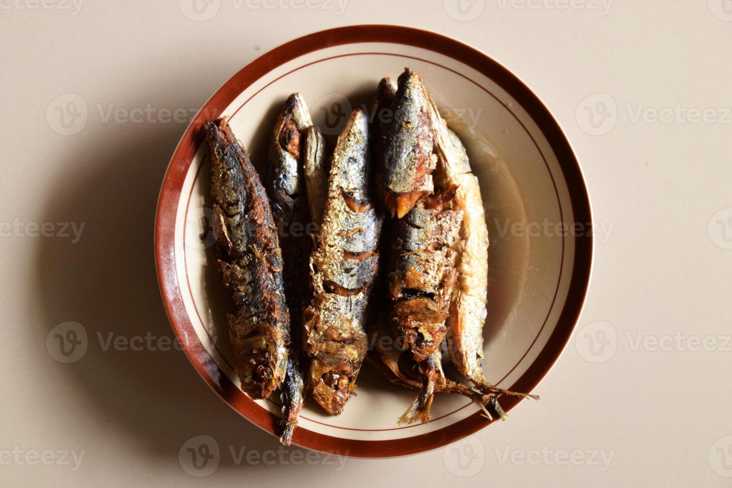 Portrait of traditional Indonesian fried fish on a plate photo