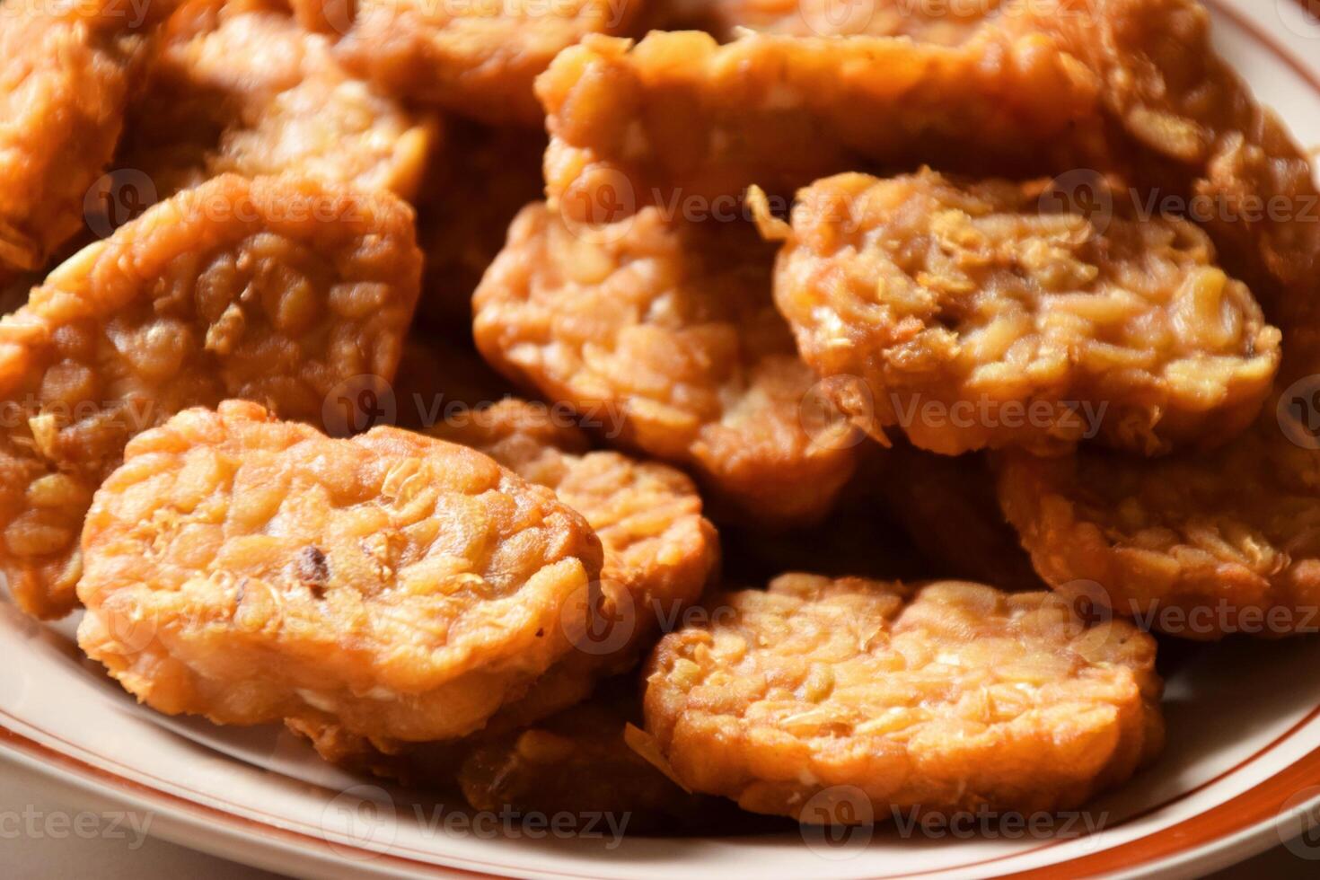 Fried tempeh closeup on a plate, traditional Indonesian delicacy photo