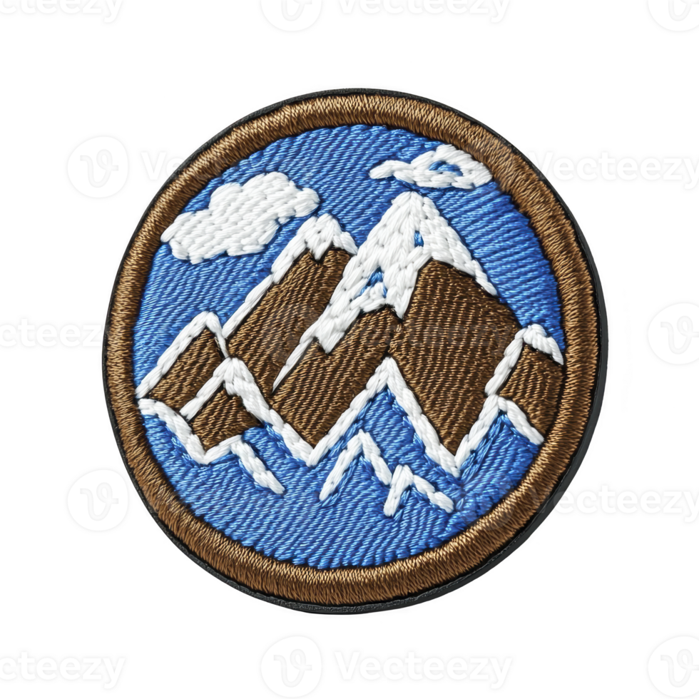 This shows round embroidered patch featuring mountain landscape with snow capped peaks and cloud against blue background. patch is bordered in brown png
