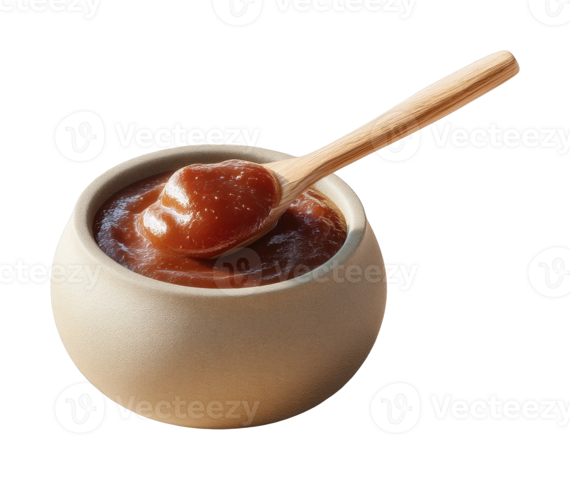 Wooden spoon with brown sauce in round bowl for culinary uses png