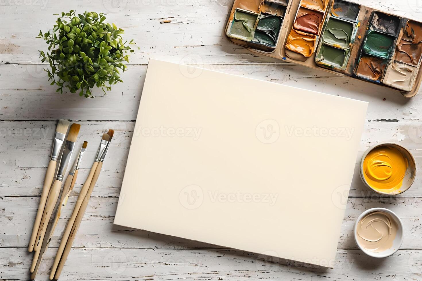 A white canvas with paint, brushes and paint pots photo