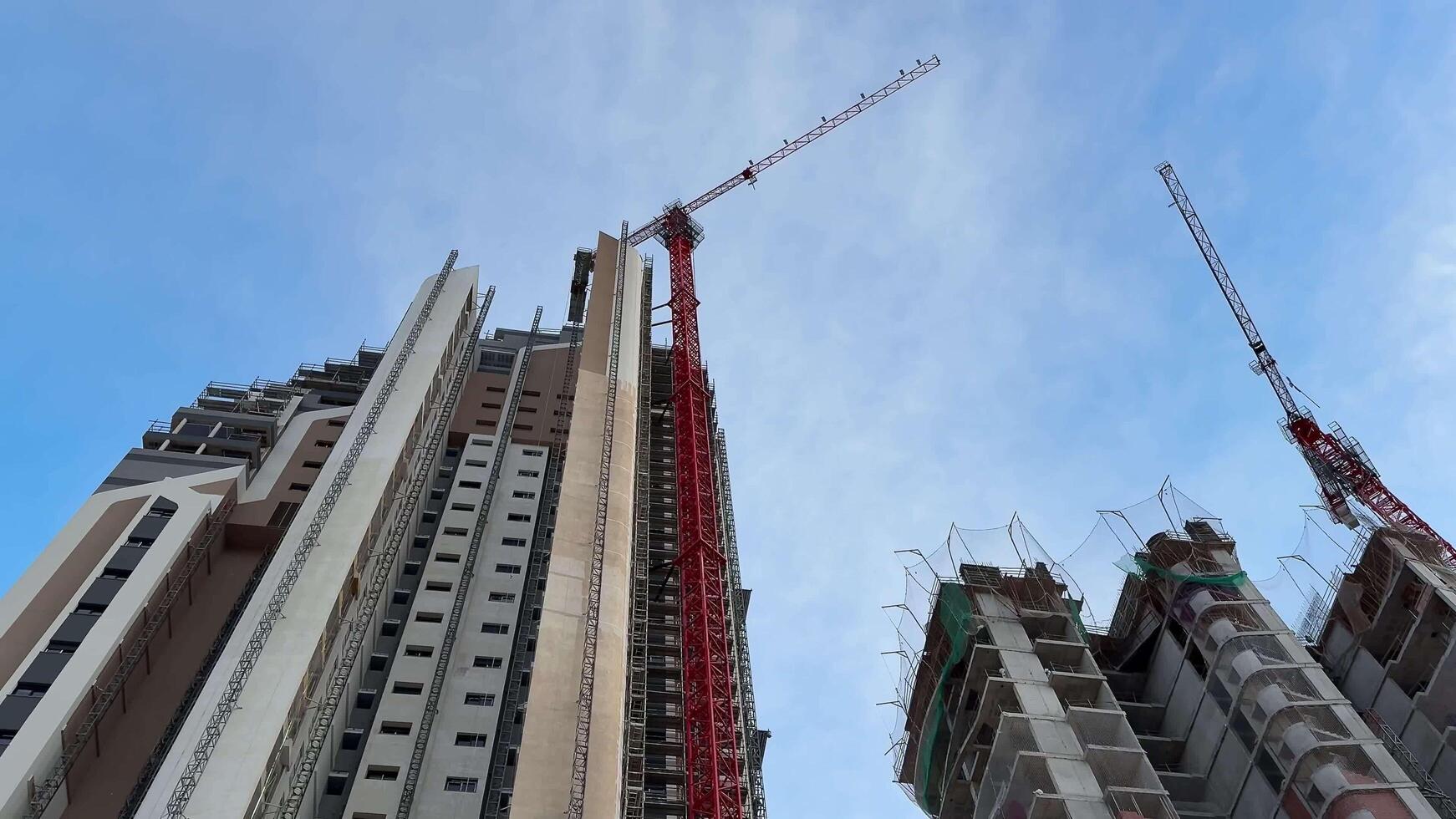 A busy construction site with tower cranes and modern buildings under construction photo