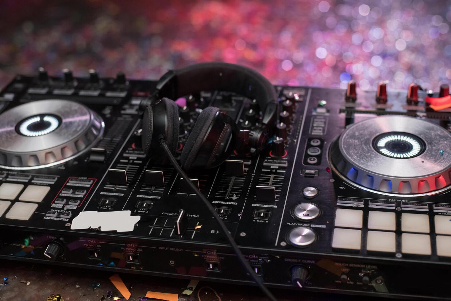 A dj mixer with headphones and a microphone photo