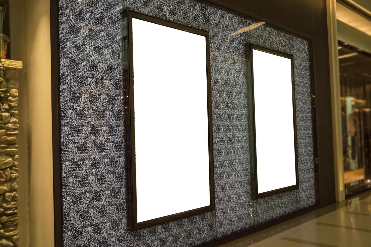 Two blank white billboards are displayed in a shopping mall photo