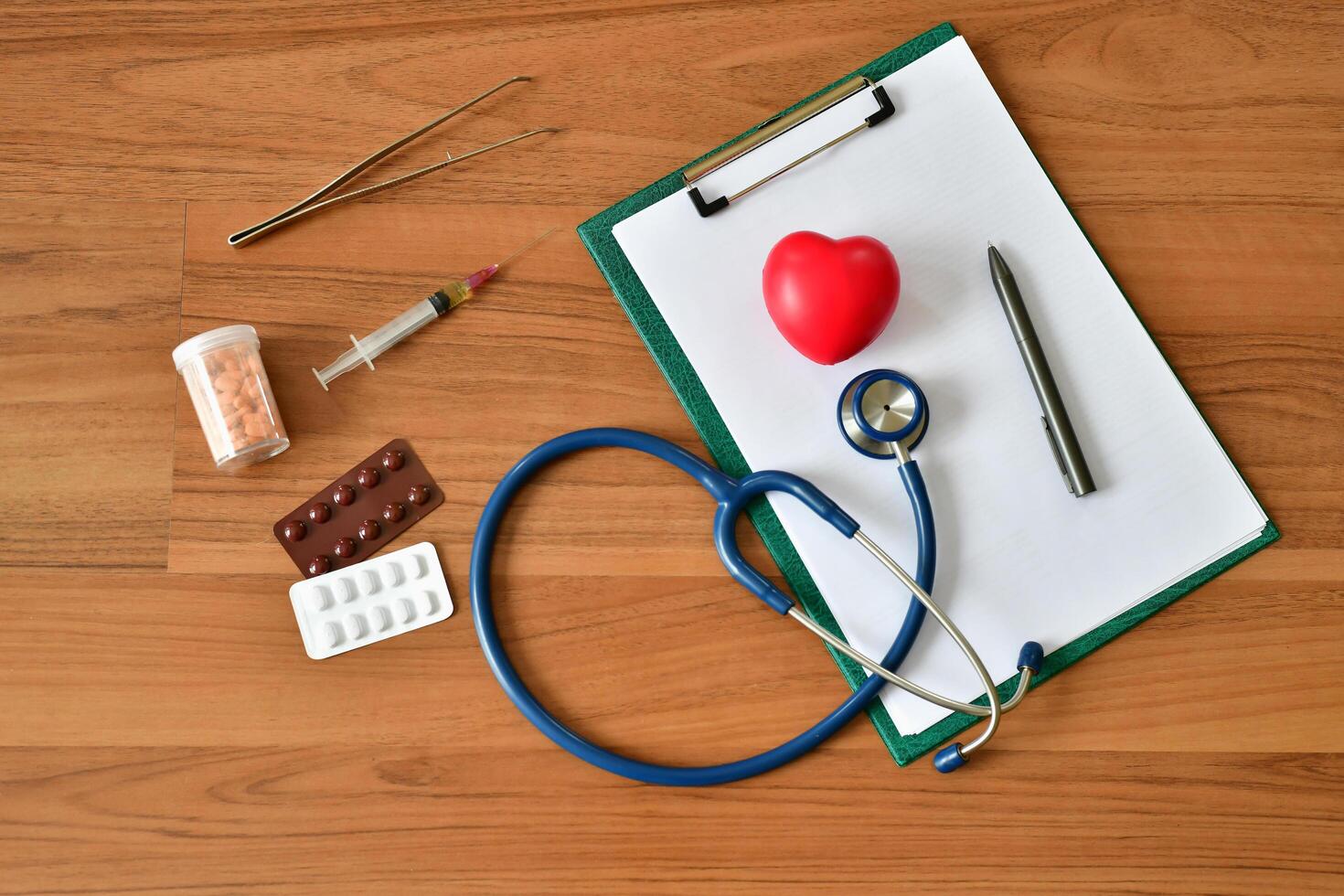 Medical supplies and a stethoscope on a wooden table photo
