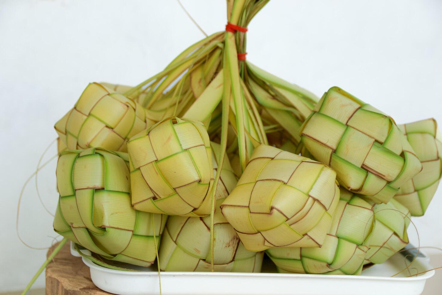 Pile of Ketupat Rice Cakes on Tray Ready to Eat photo