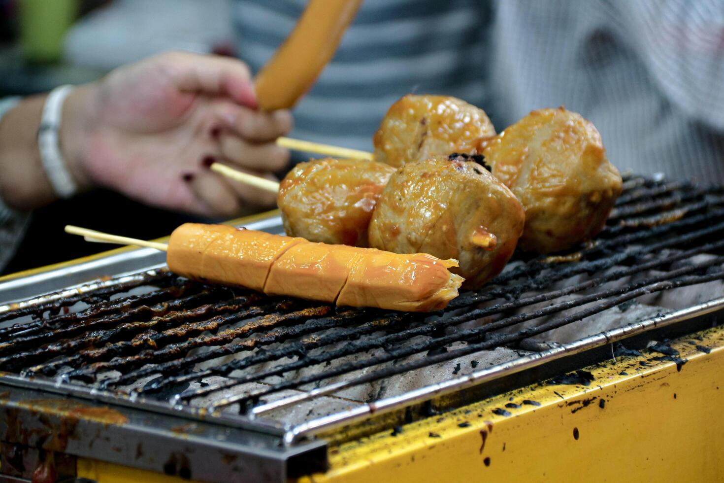 Grilling Sausage and Meatballs on Skewers Over a Hot Grill photo
