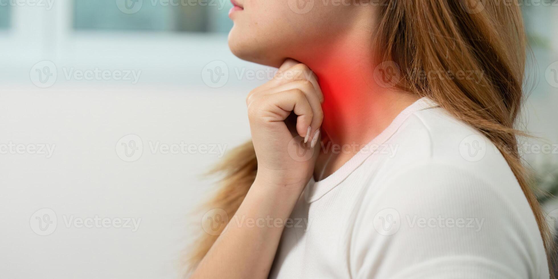 Health Monitoring. Woman feeling throat pain at home. photo
