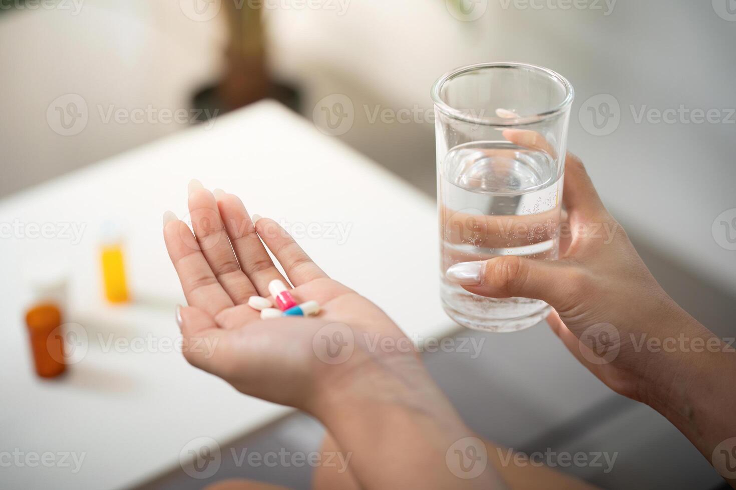Health routine. Woman preparing to take pills with water for wellness. photo