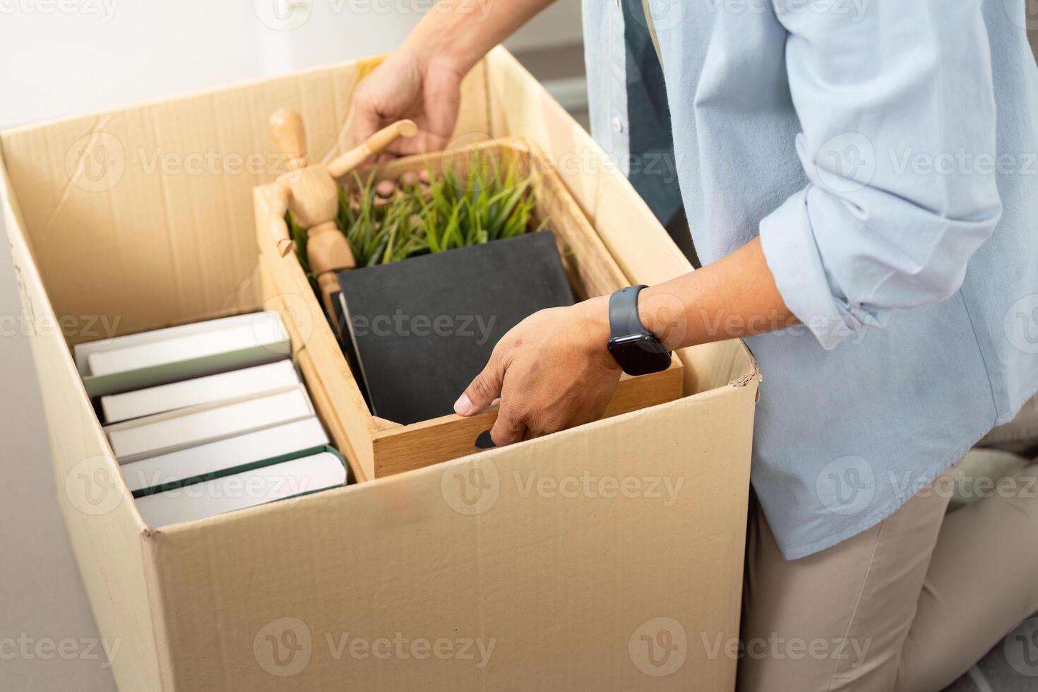 Gay man organizing items while unpacking a box in a new home photo