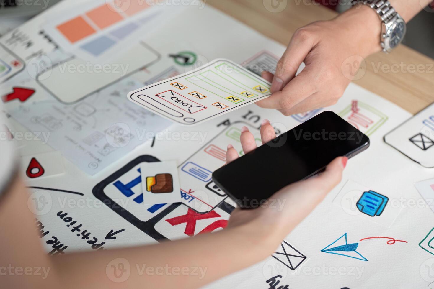 UX and UI Design. Hands interacting with smartphone and design elements for app development. photo