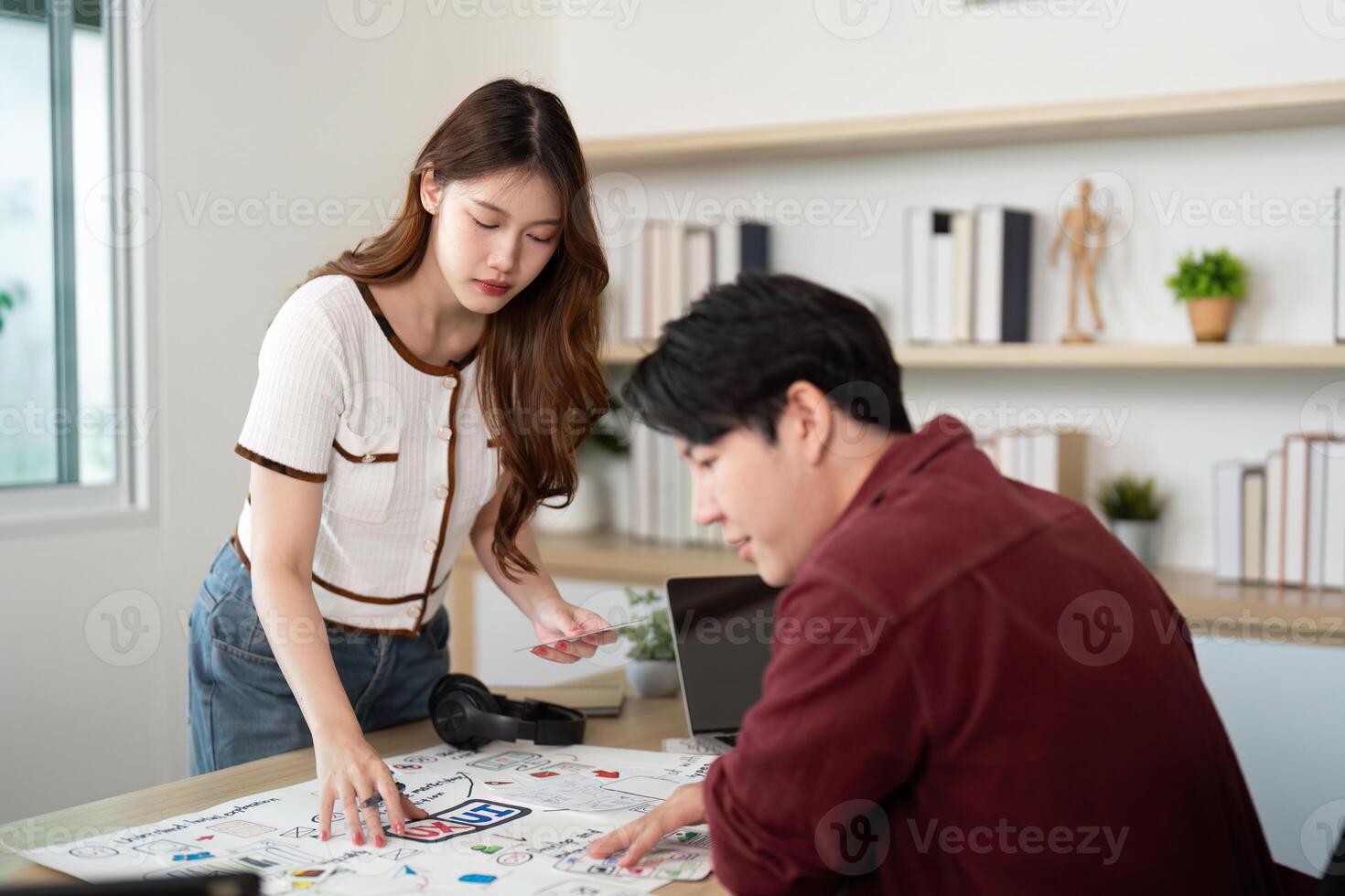 UX UI design brainstorming. Young woman presenting ideas to a colleague. photo