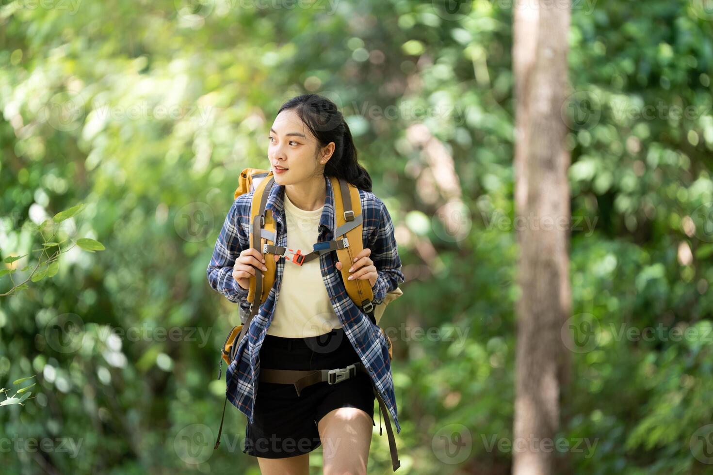 Woman hiking in green forest photo