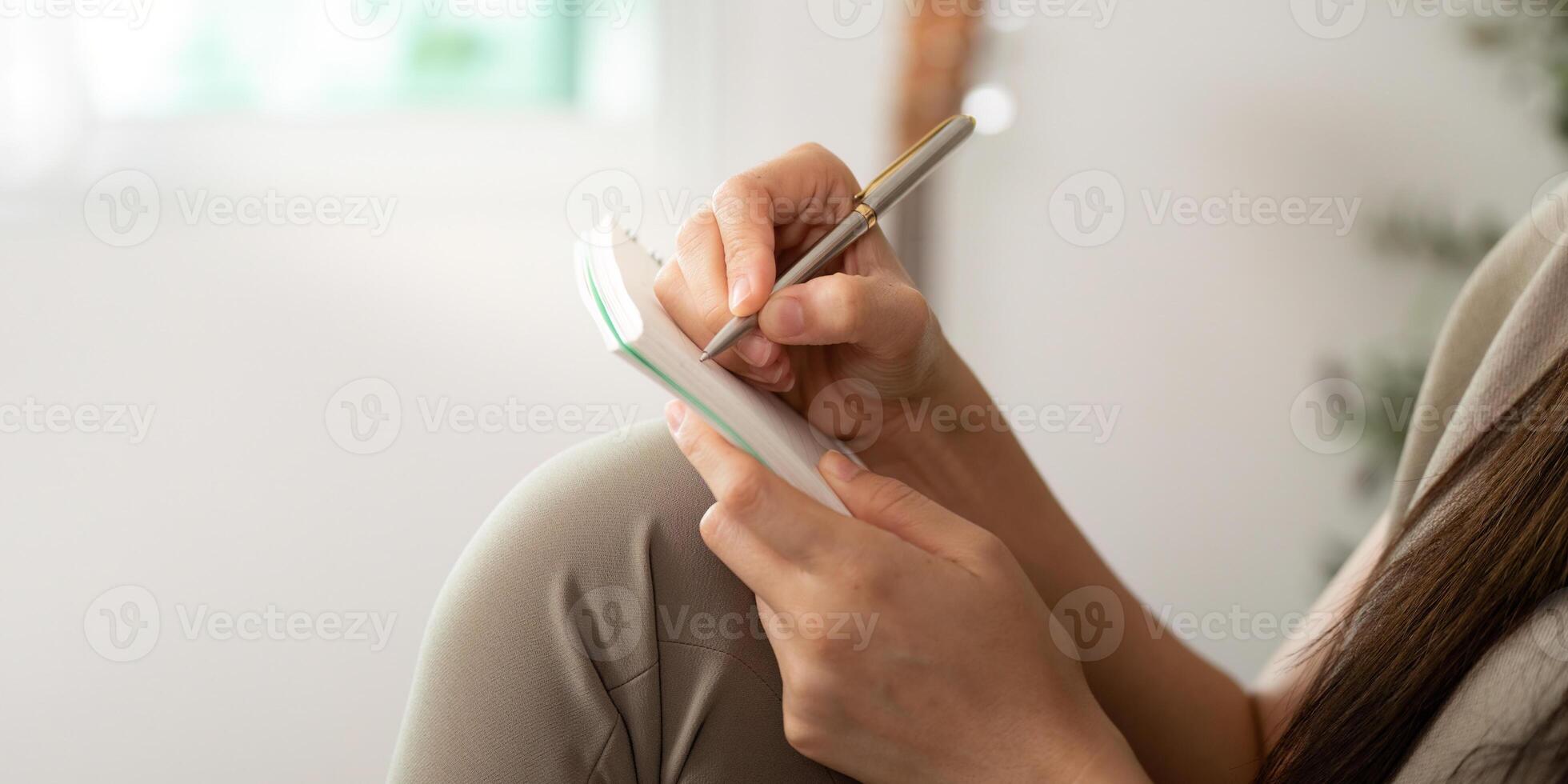 Person writing in a notebook photo