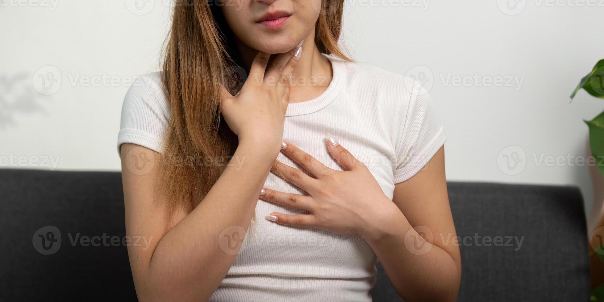 Health Awareness. Woman feeling throat discomfort at home. photo