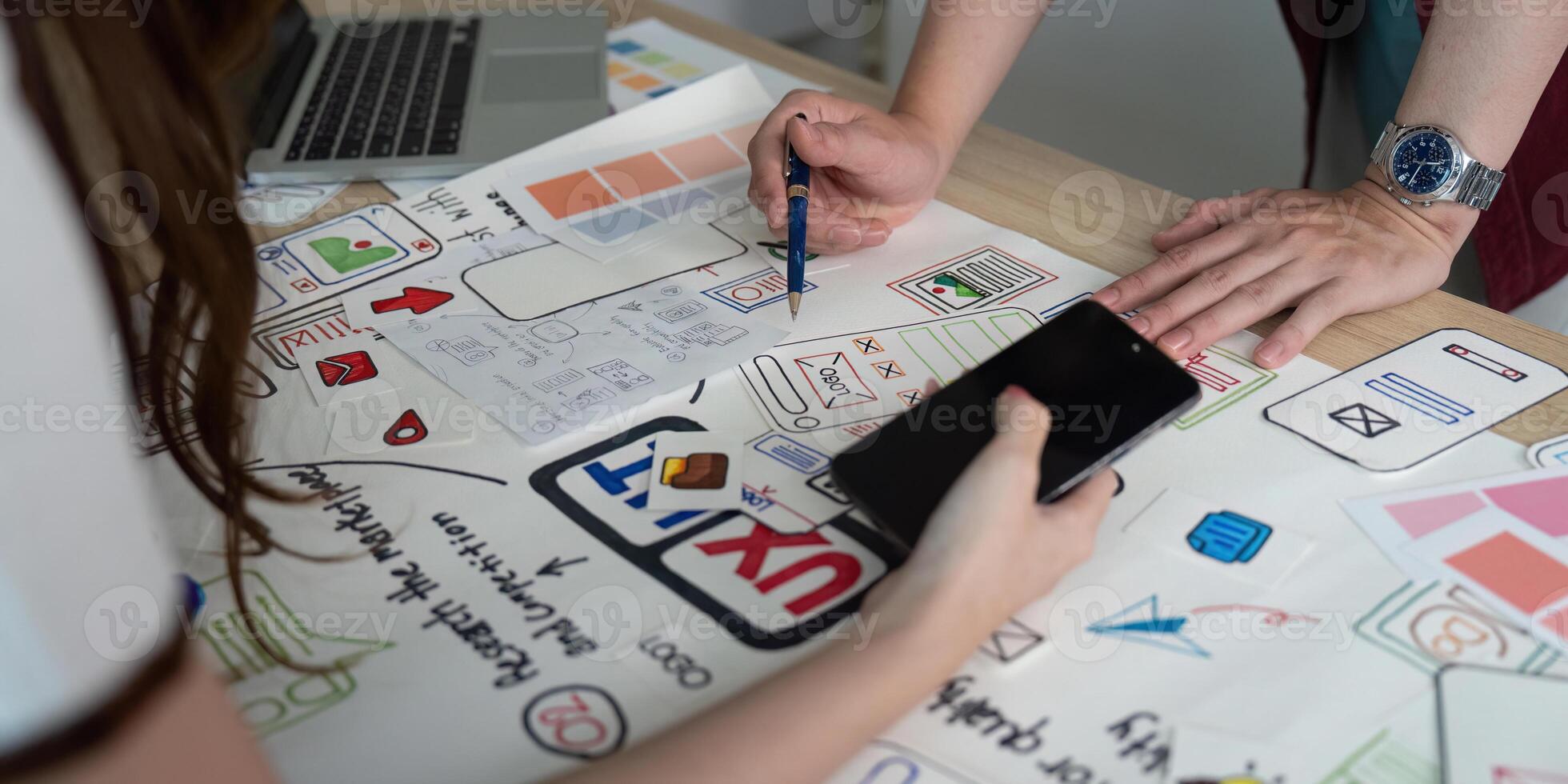 Hands-on UX and UI design collaboration with sketches. photo