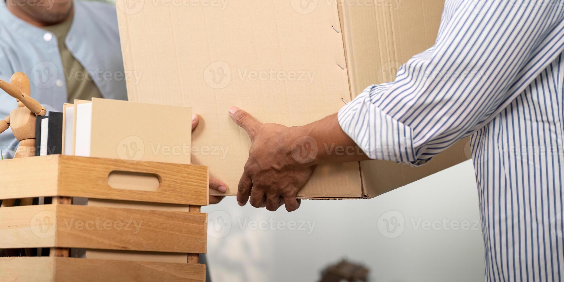 Gay couple sharing a moment while unpacking boxes in their new home photo