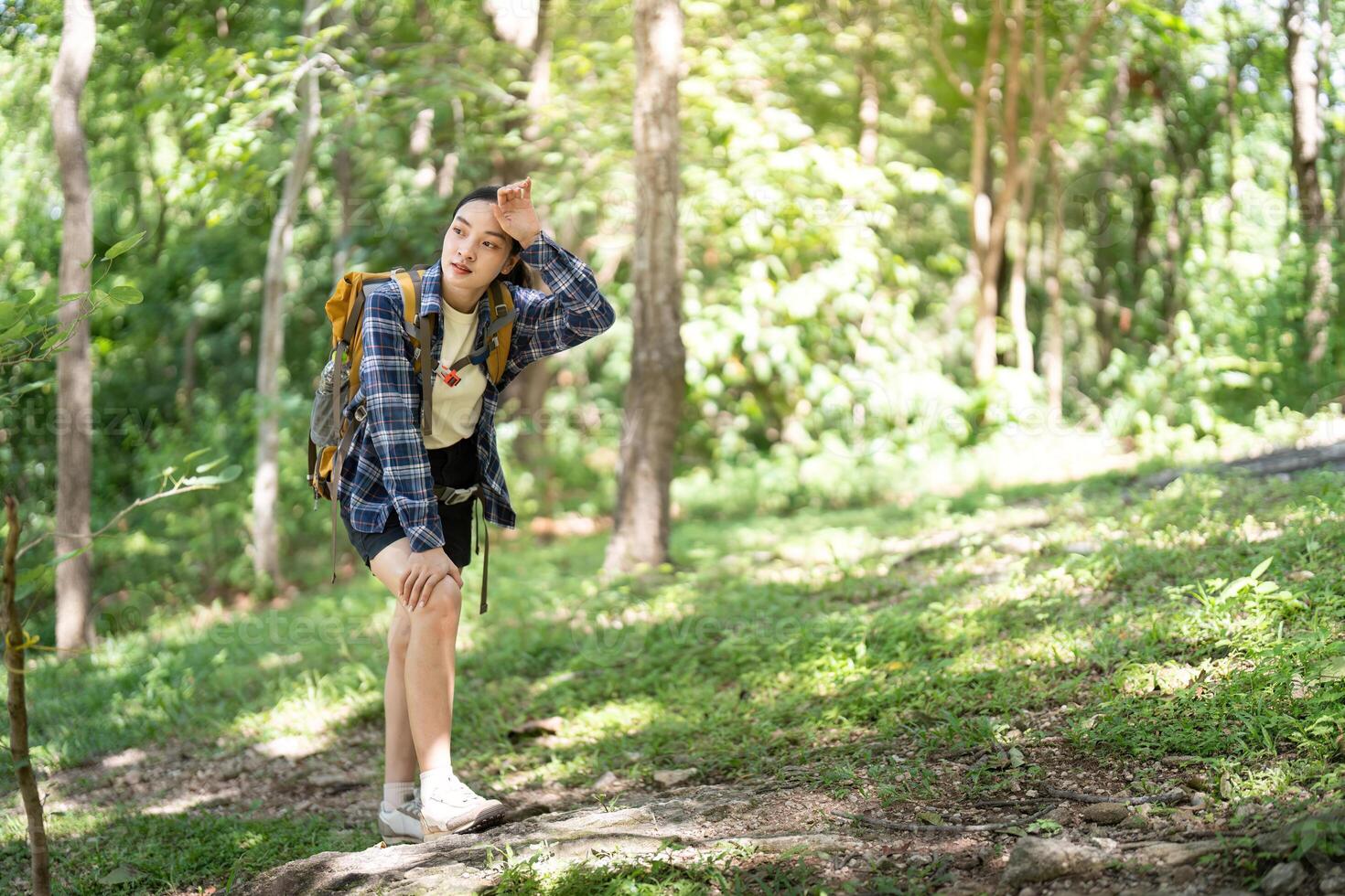 Woman hiking in a green forest photo