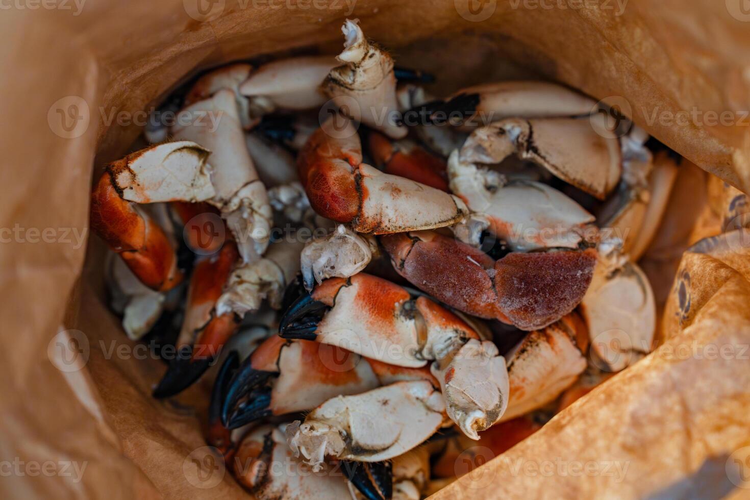 Close-up of a plate with fresh boiled Arctic crab claws, a luxurious and sought-after seafood delicacy, ready to be served. This gourmet dish is popular in fine dining and seafood restaurants. photo