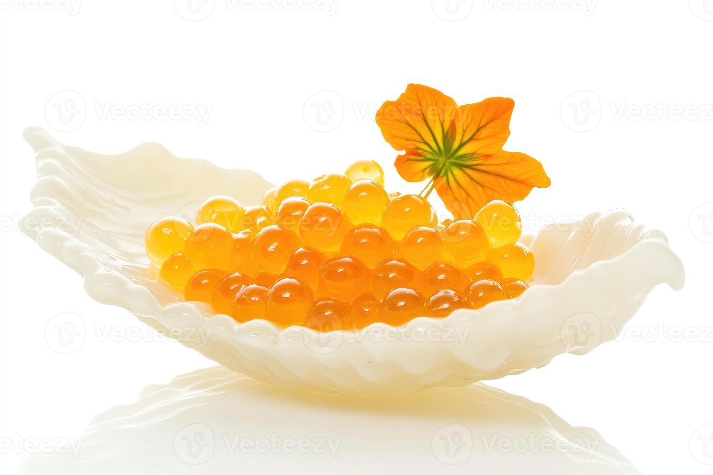 A white shell holds vibrant orange fish roe, garnished with a bright yellow flower. The scene emphasizes gourmet cuisine and elegant presentation. photo