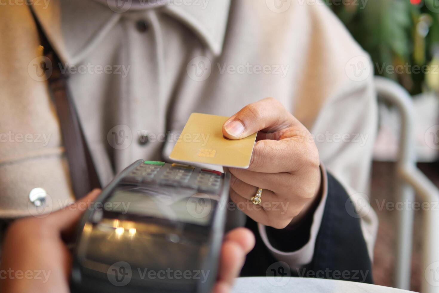 Person making a contactless payment at a cafe photo