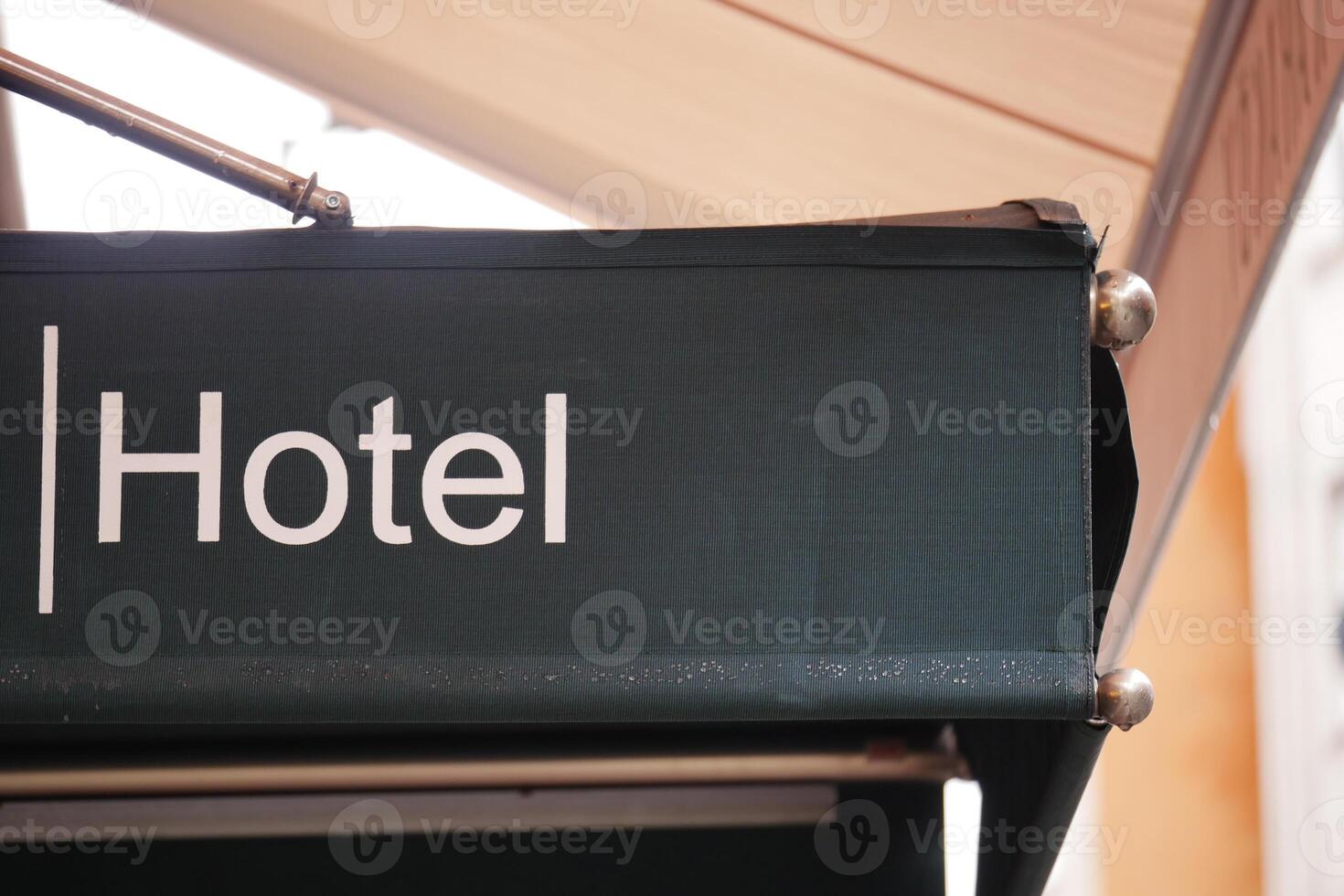 Hotel entrance sign at a busy city location in daylight photo