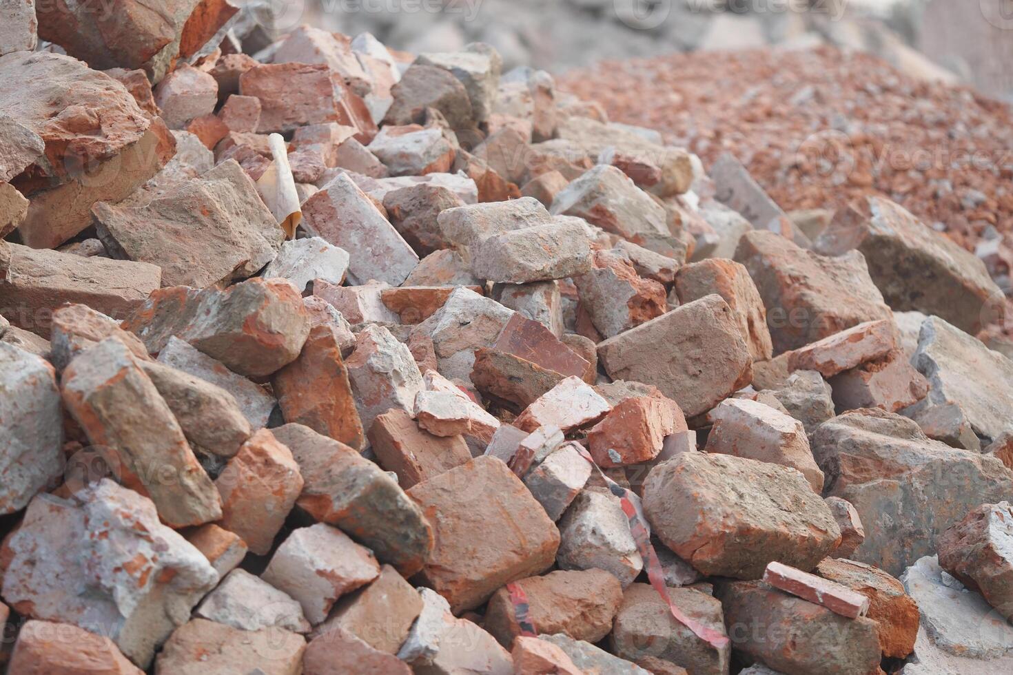 Pile of bricks and rubble at a construction site in daylight photo