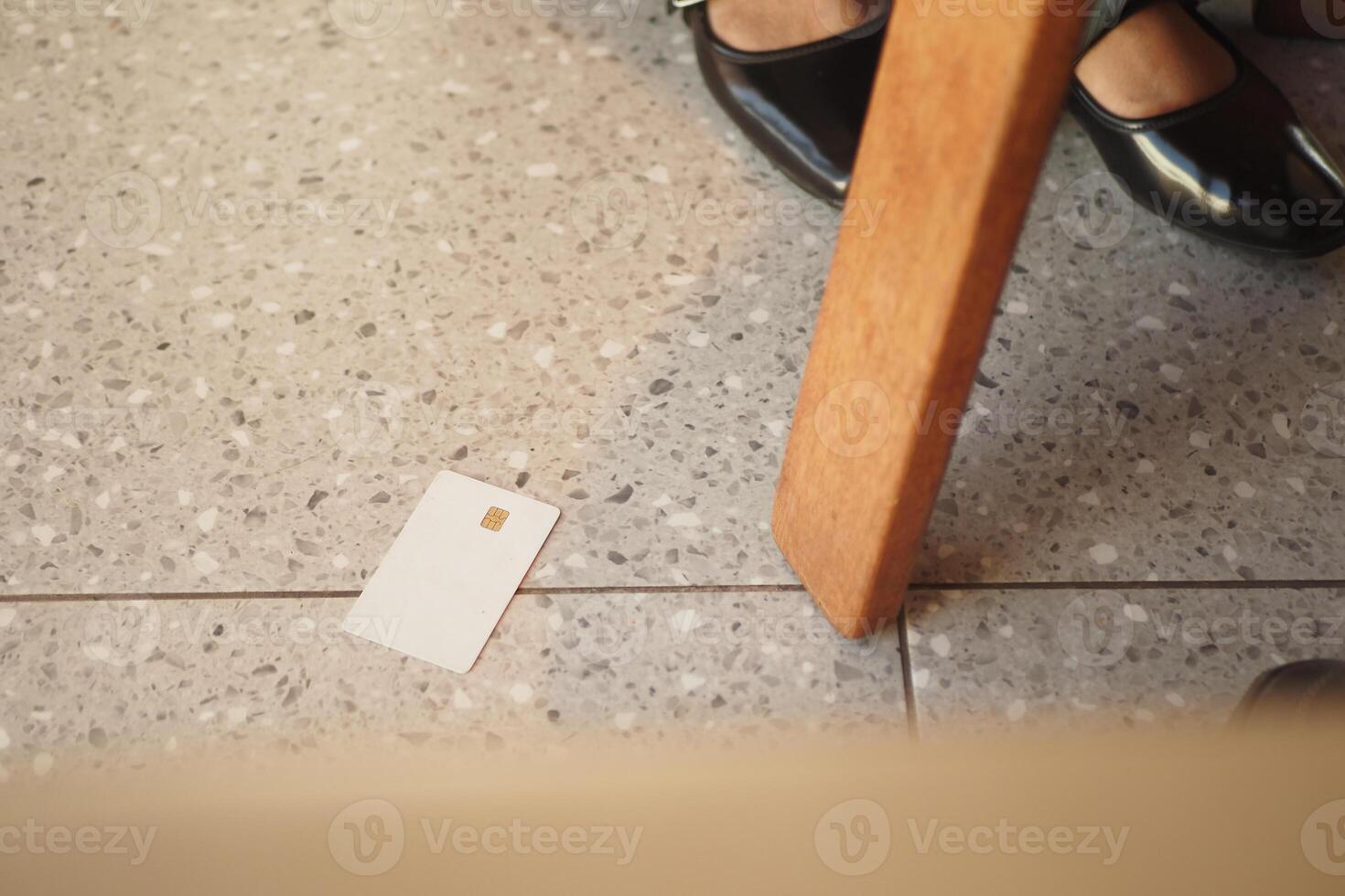 Credit Card forgotten on the floor near a chair in a cafe photo