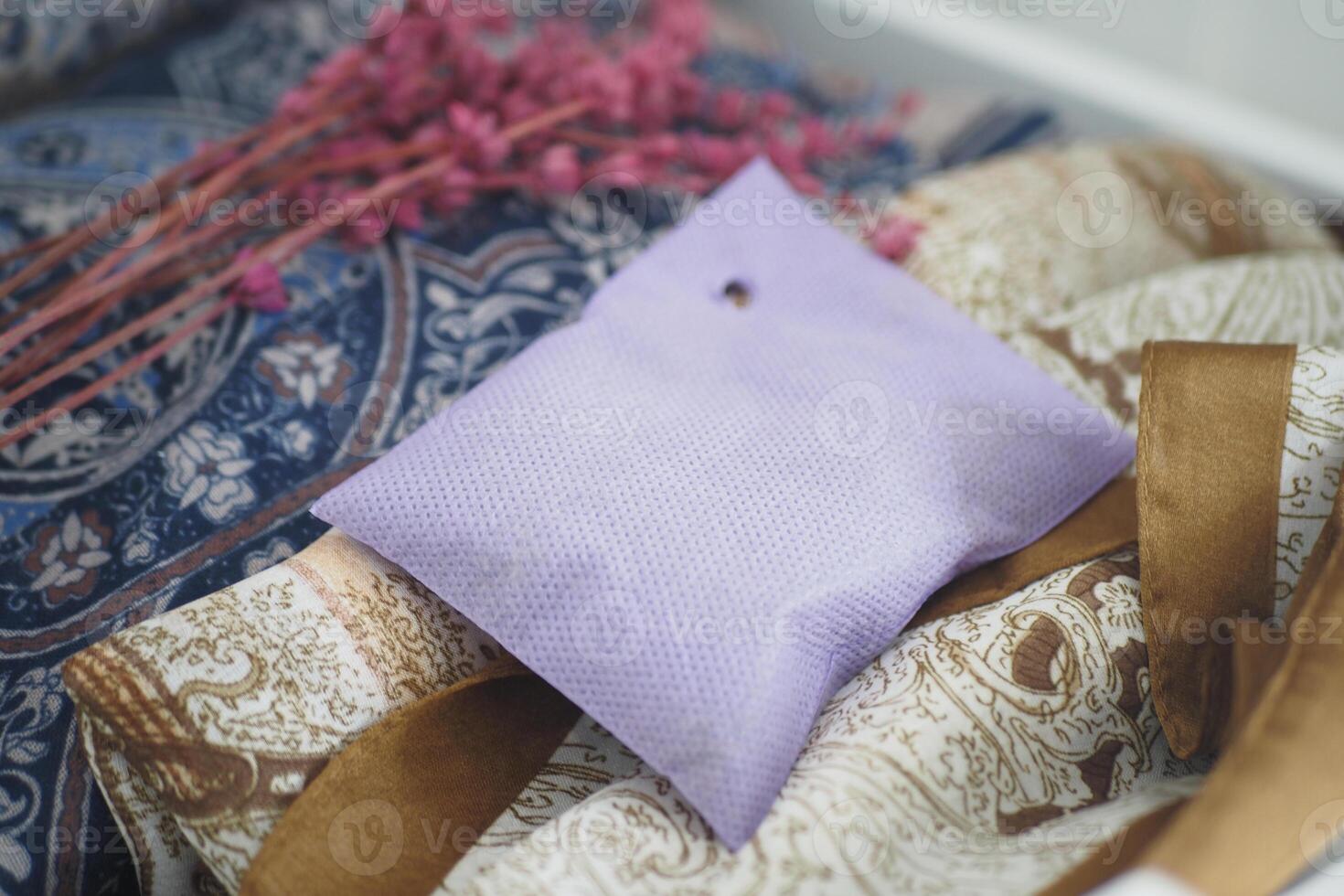 Lavender sachet on patterned fabric with flowers photo
