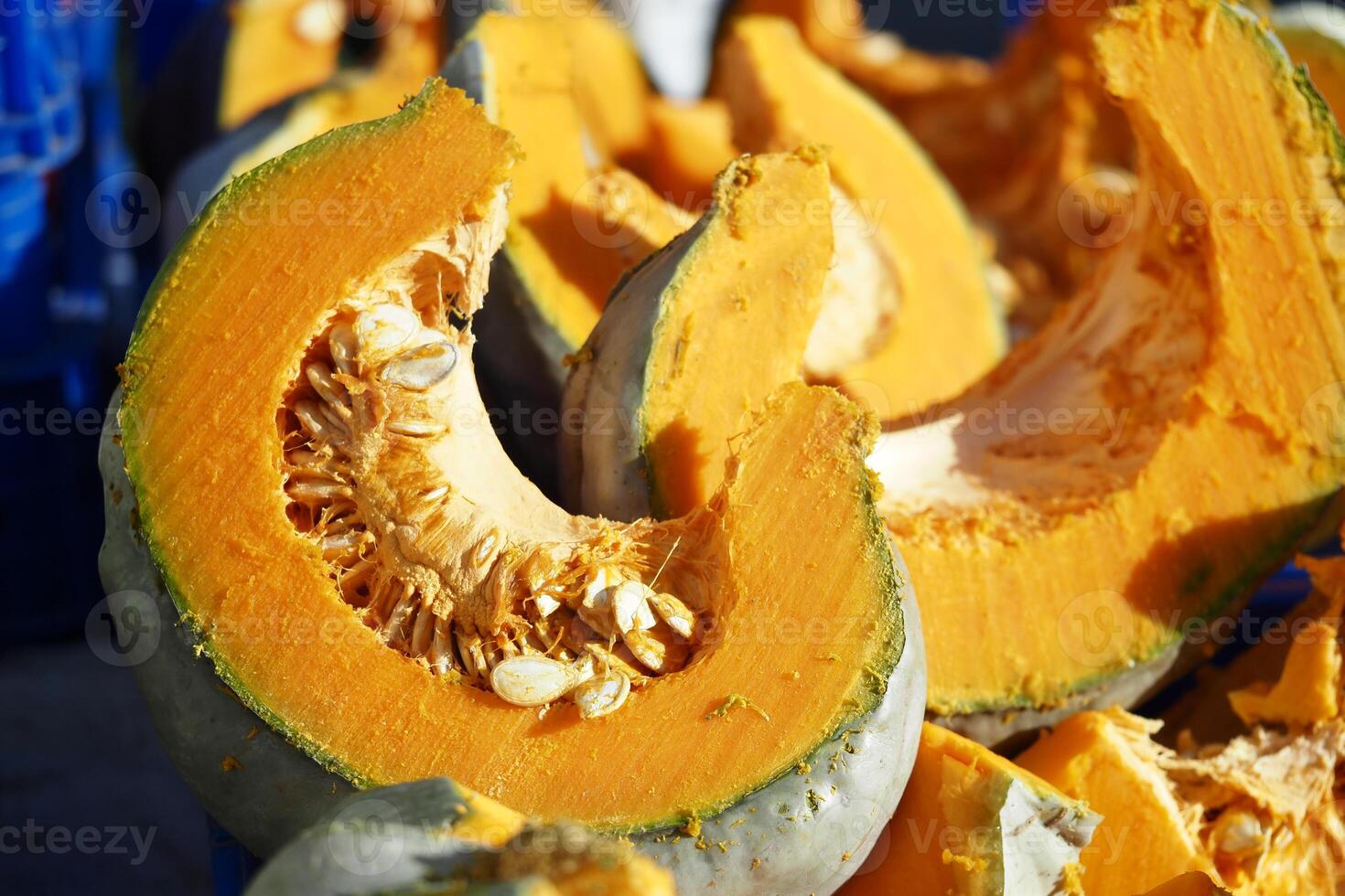 Freshly cut pumpkin pieces at a local market photo