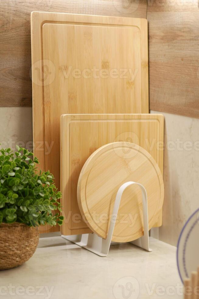 Wooden cutting boards neatly organized in modern kitchen photo