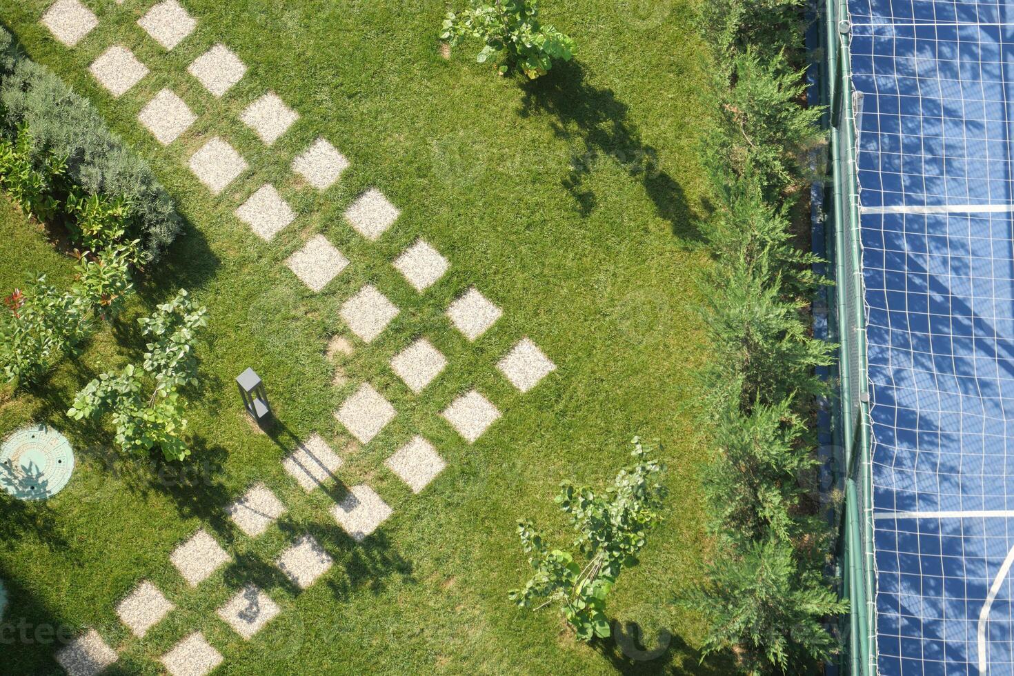 Garden pathway and tennis court view from above photo