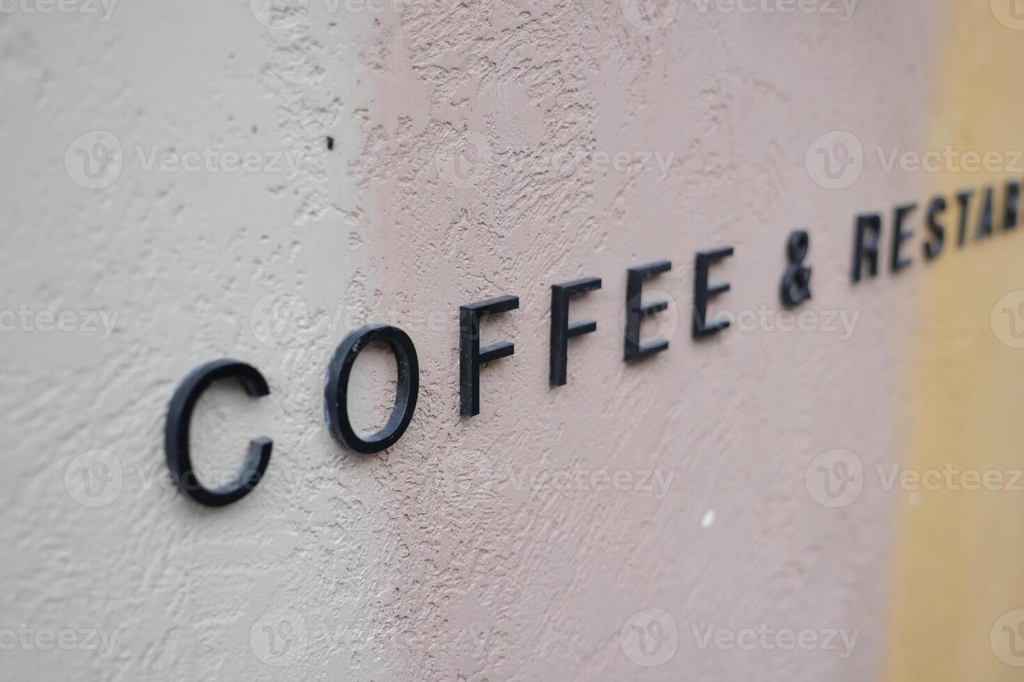 Coffee and restaurant sign on a textured wall photo