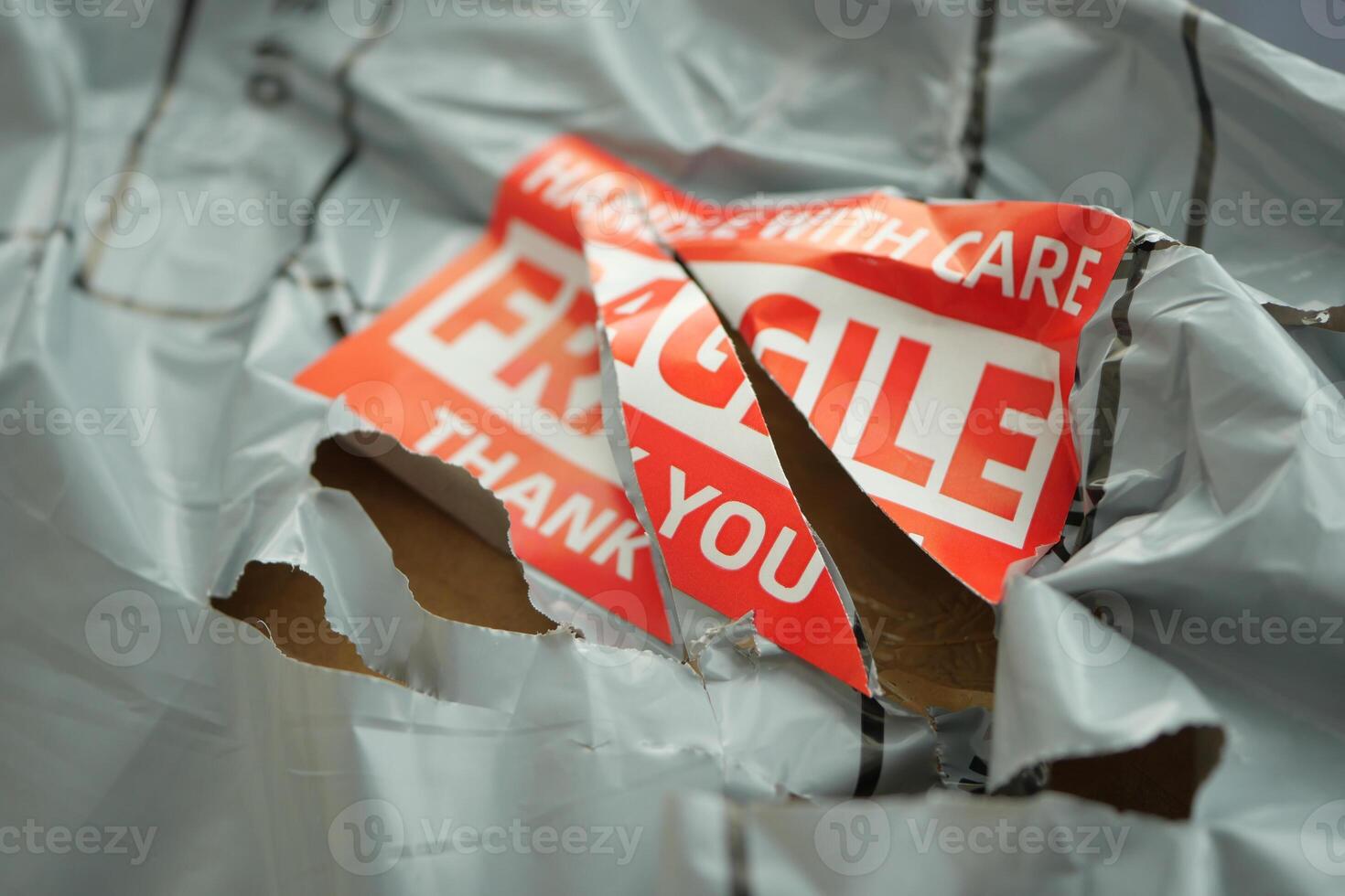 Delivery package showing damage with fragile notice photo