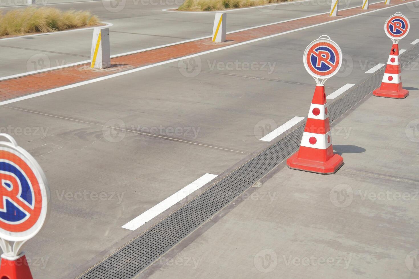 Road safety cones mark construction zone near pavement photo