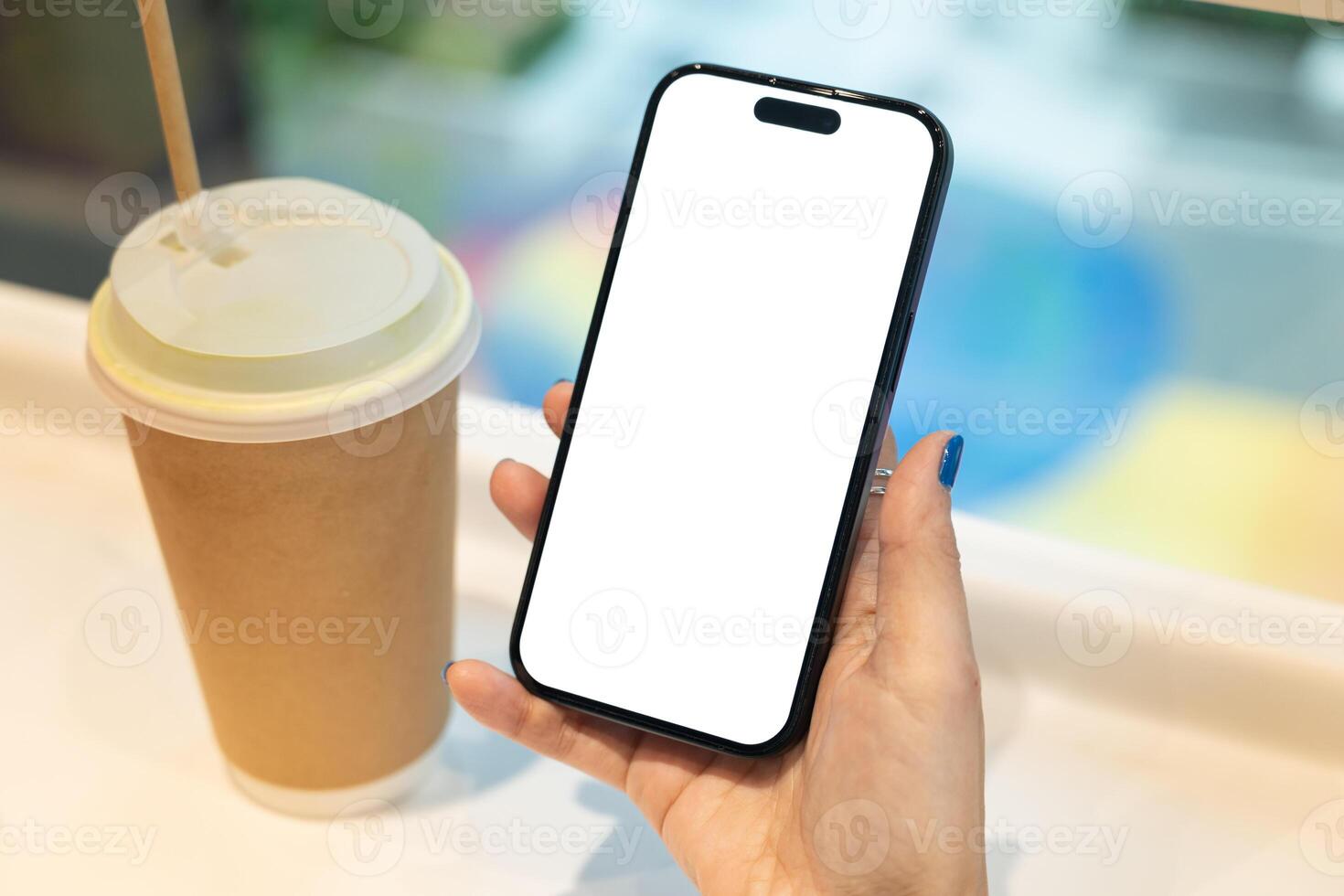 Woman Hand Holding Smartphone with Blank Screen and Coffee Cup. Ideal for app or website mockup. technology, lifestyle, coffee culture, or mobile app presentation. photo
