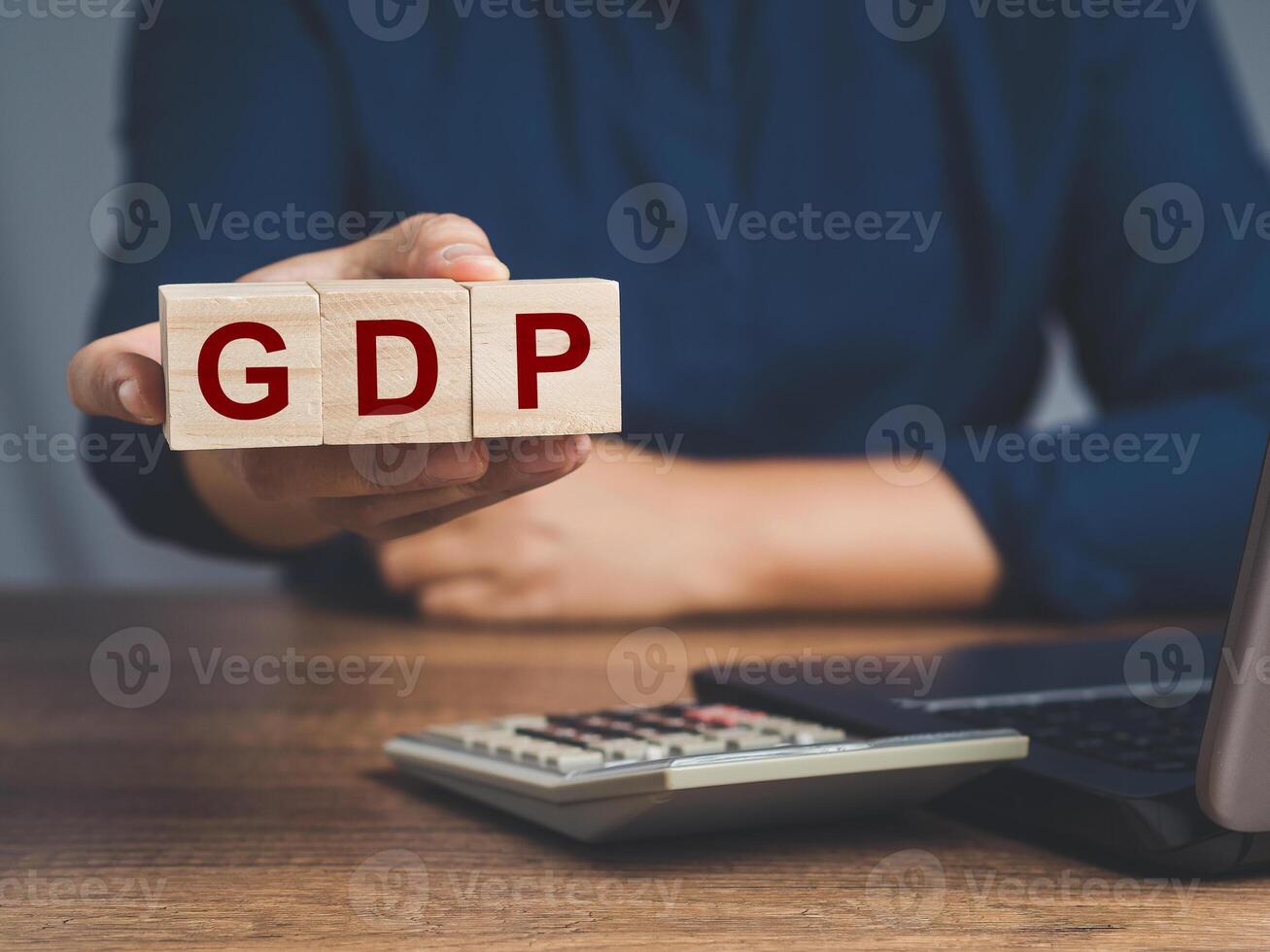 GDP or gross domestic with wooden cubes or blocks in hand photo