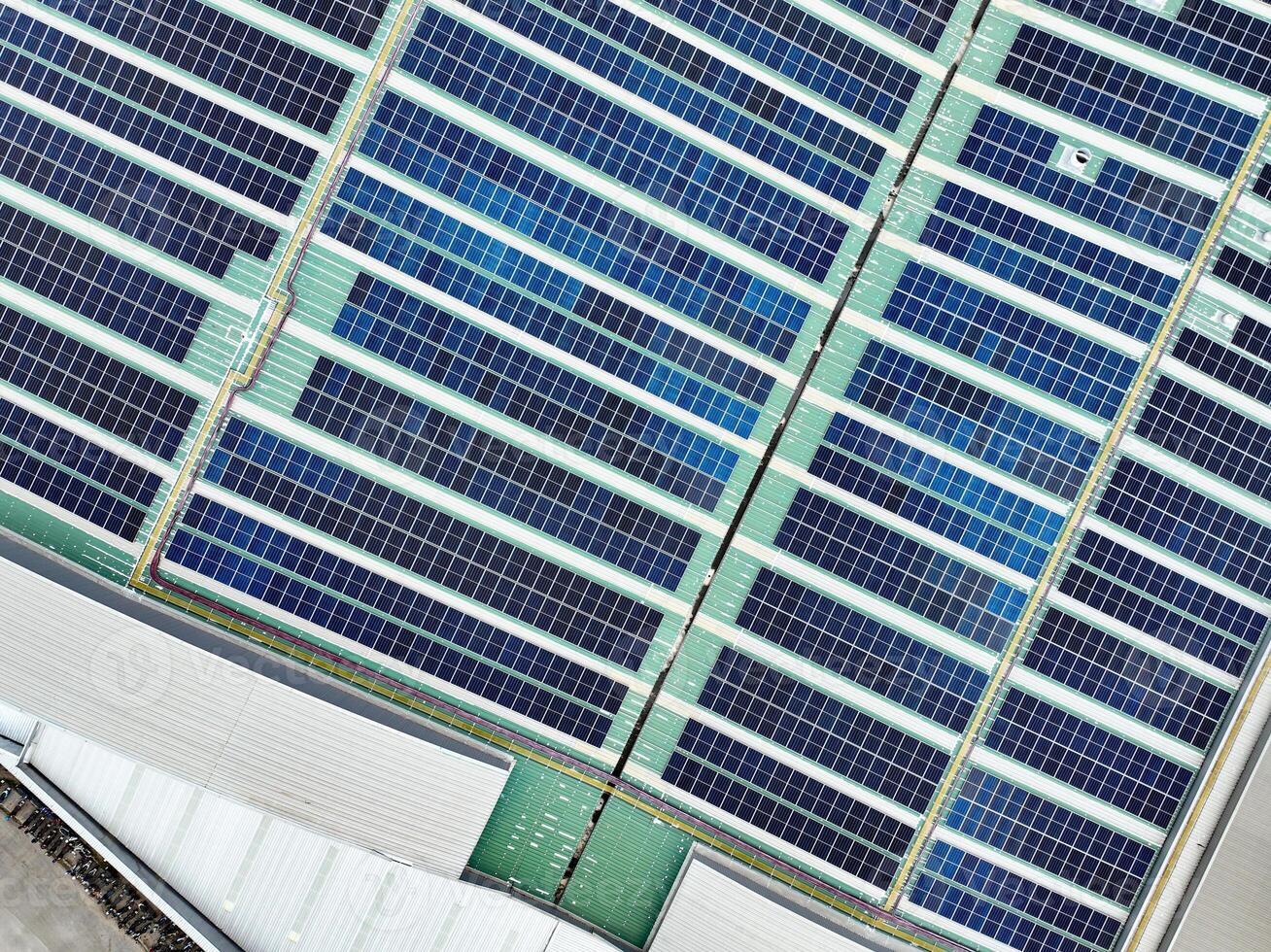 Rooftop solar panels on an industrial plant building. Ecofriendly electricity production, renewable energy efficiency, and sustainable technology for reducing carbon emissions in commercial settings. photo