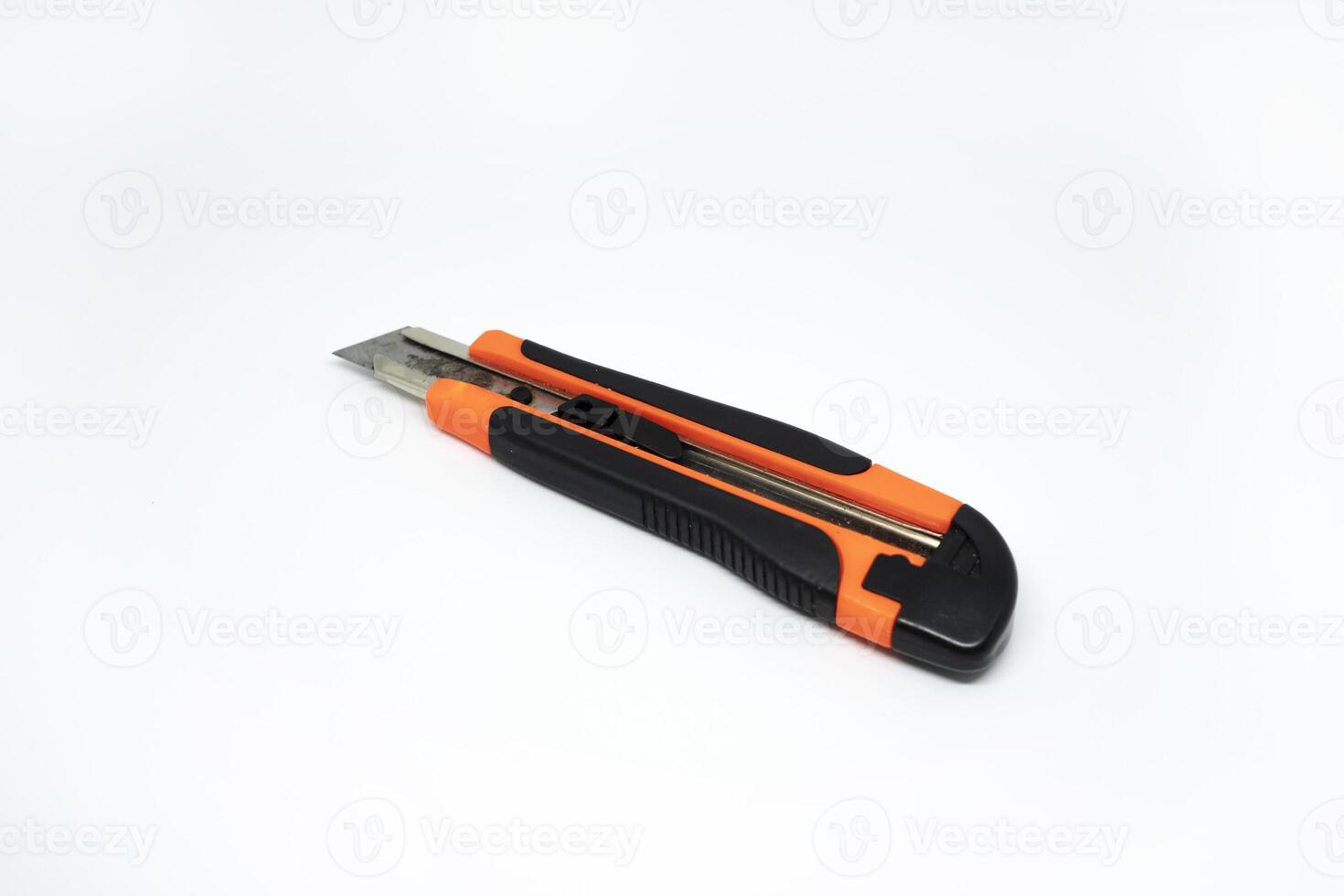 Closeup view of orange cardboard cutter isolated on white background. Box cutter isolated photo