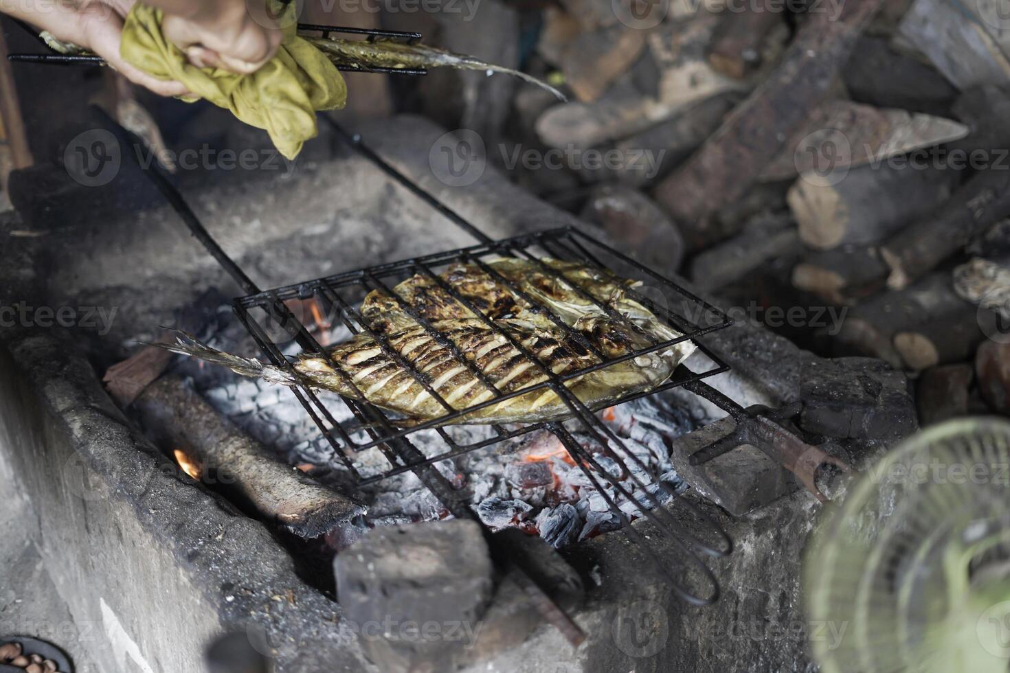 big fish grilled on charcoal photo