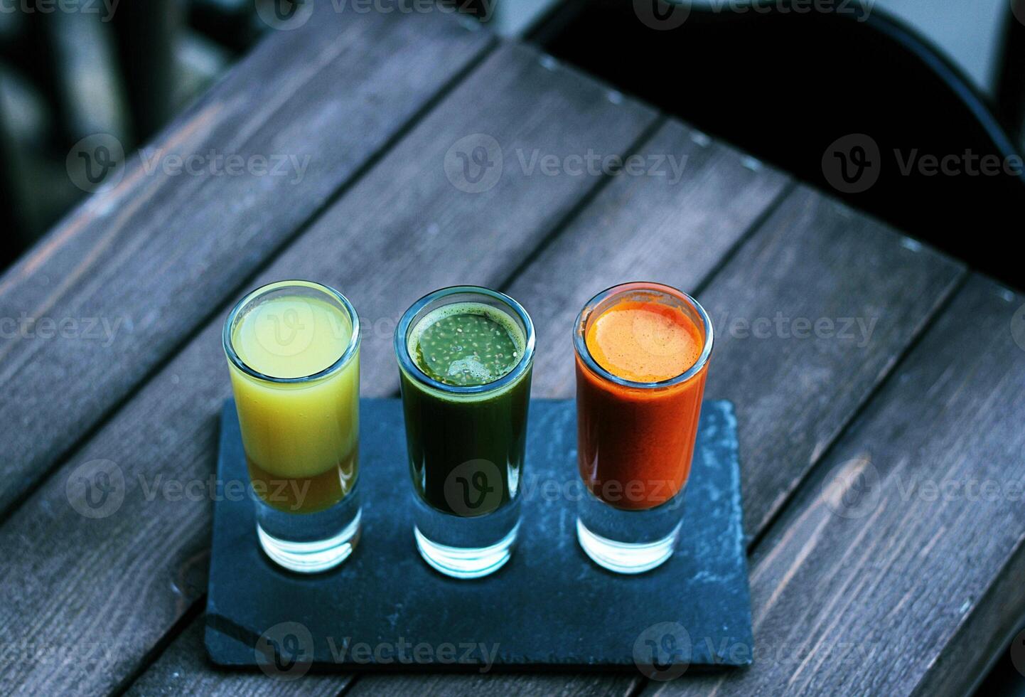 Colorful Fruit Juice Shots Healthy Detox Trio on Wooden Table photo