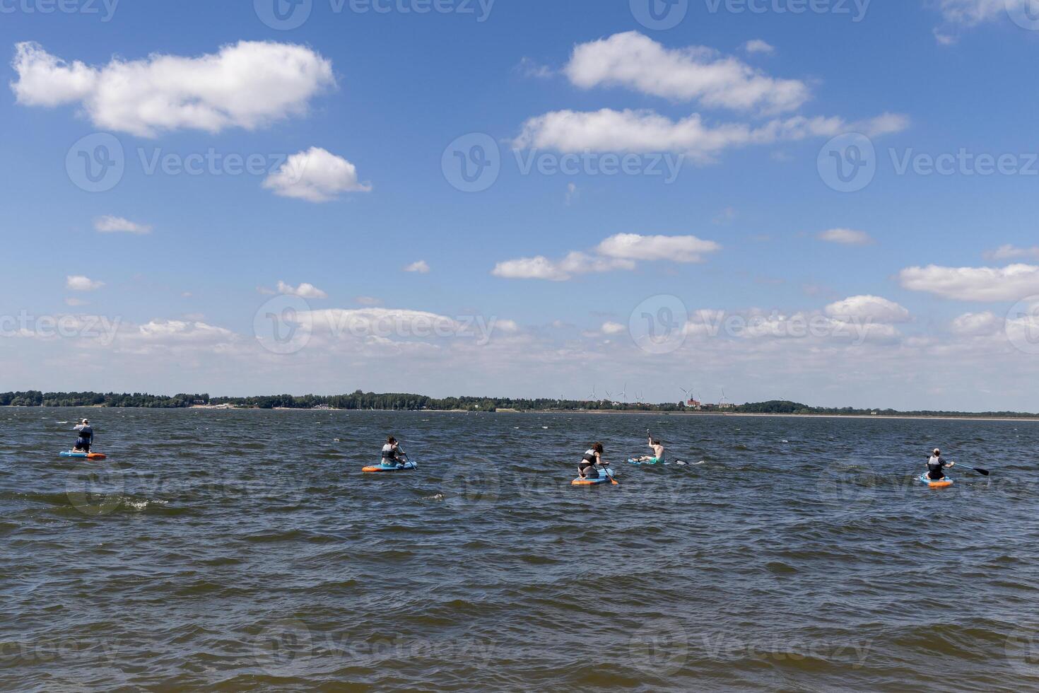 SUP touring group on Mitkow Bay, Poland. Landscape photo