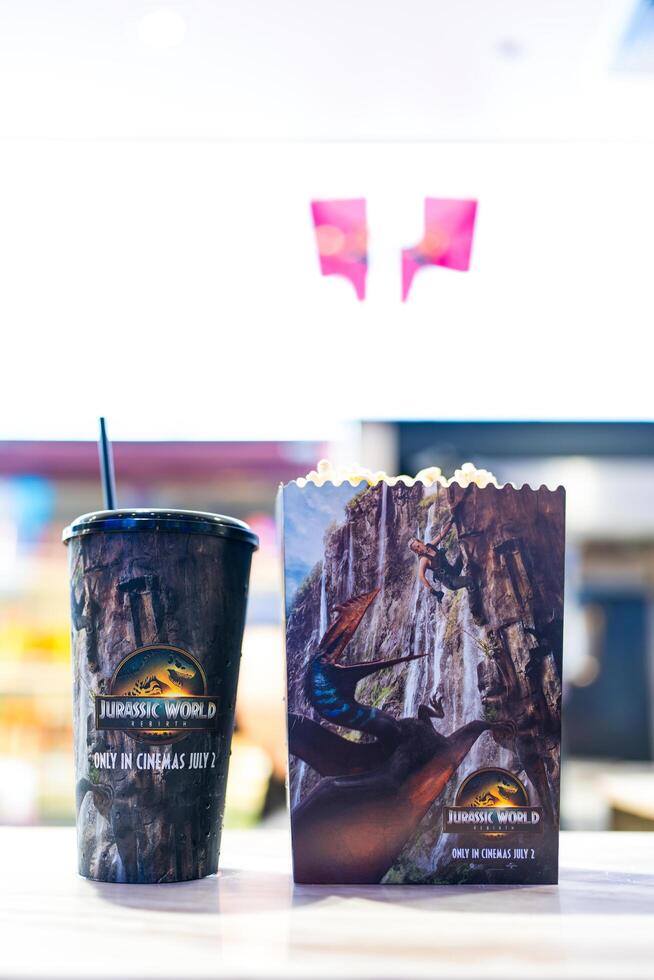 Bangkok, Thailand - July 8, 2025 Set of popcorn and soft drink cup with pattern Jurassic World Rebirth from Major Cineplex photo