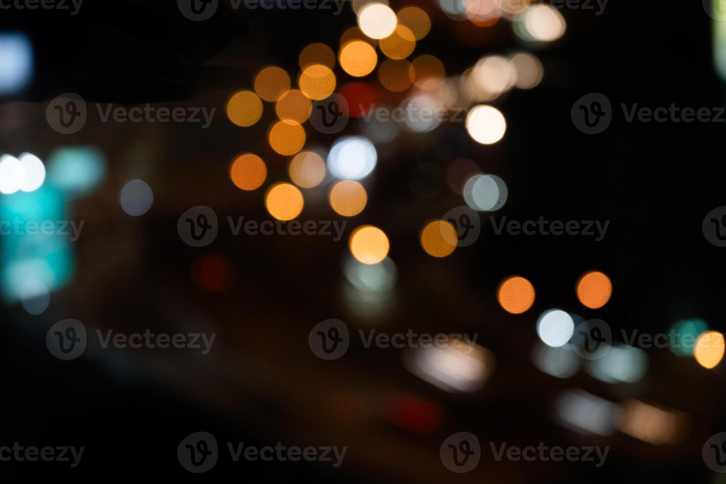 Night shows reflection from cars tail lights and street lighting on road. photo