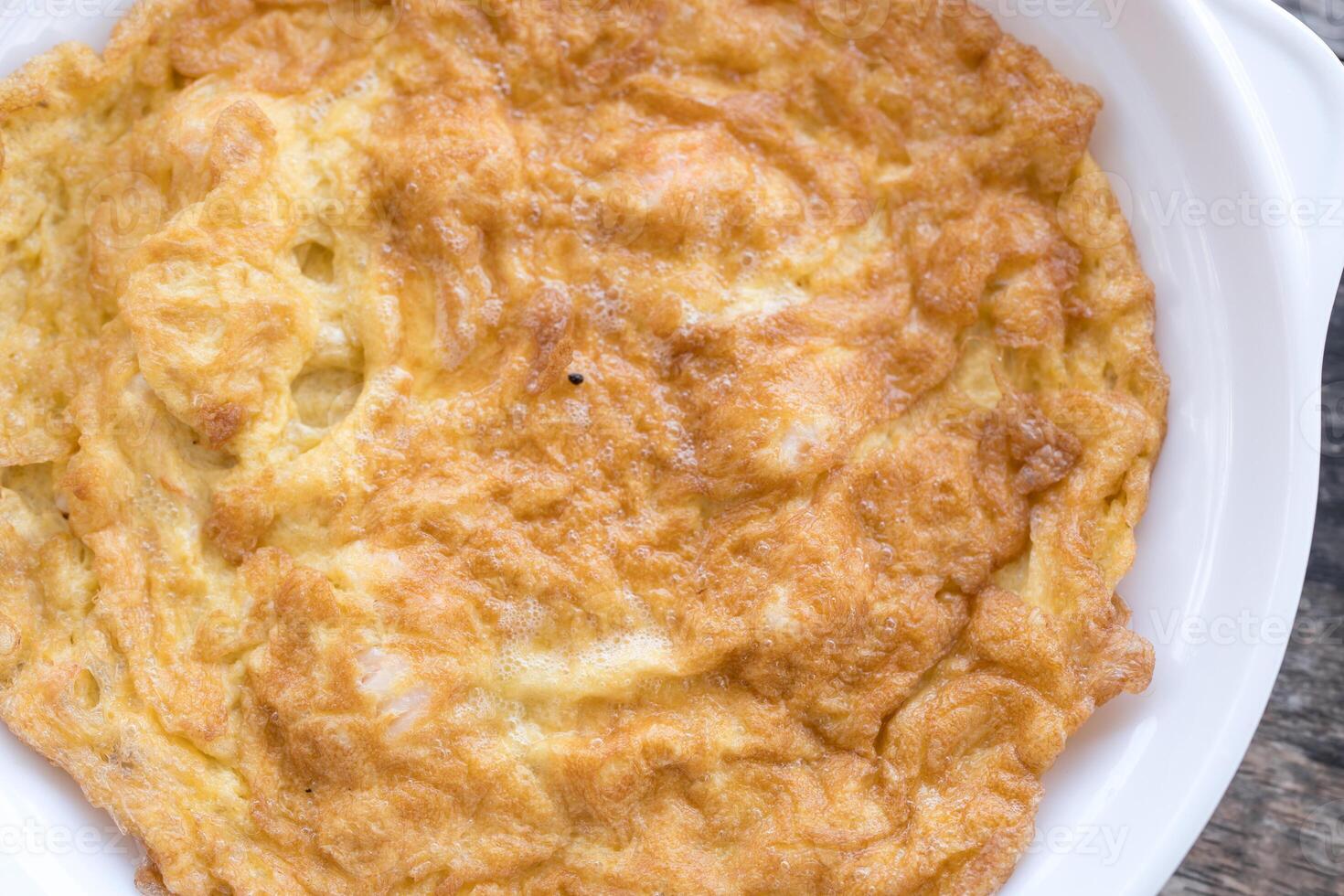 Thai style omelet stuffed served on a white plate photo