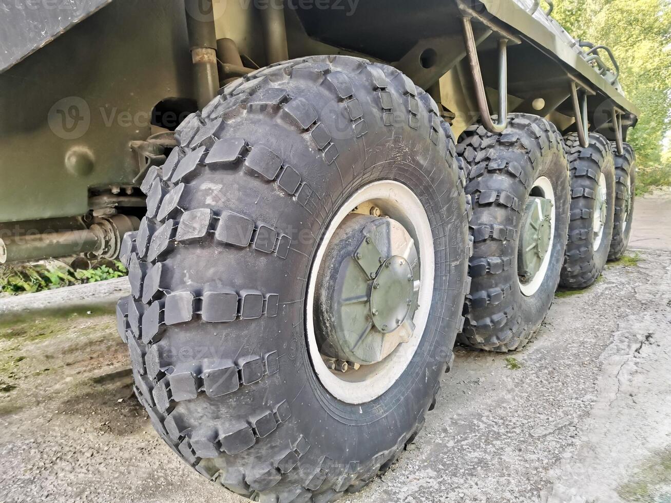 Close-up of military armored vehicle wheel and tire texture photo