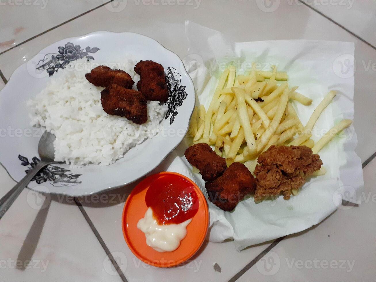 Crispy Fried Chicken, Fries, and Rice Meal on a Patterned Plate photo
